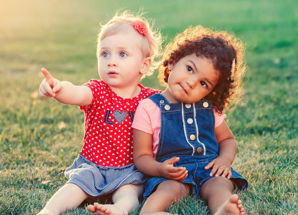 Two adorable toddlers sitting together